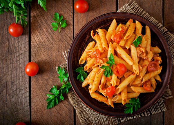 penne-pasta-tomato-sauce-with-chicken-tomatoes-wooden-table-min